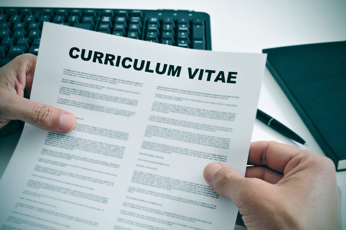 man in his office checking a curriculum vitae